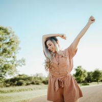 A cheerful woman enjoying a sunny day outdoors in Dayton, Ohio.